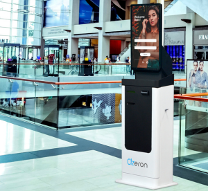 A kiosk in a shopping center displays advertisement and provides guidance and support to customers.